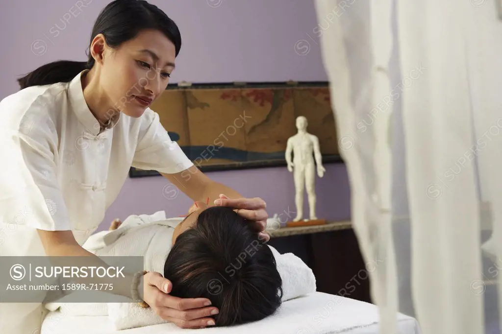 African woman receiving Acupuncture treatment