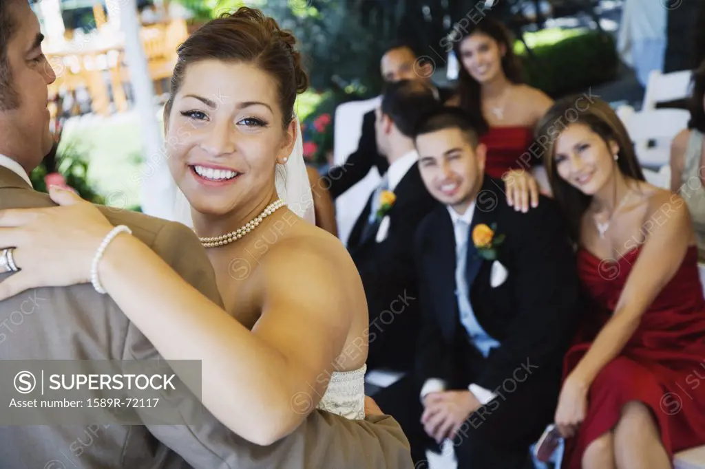 Hispanic bride dancing with father