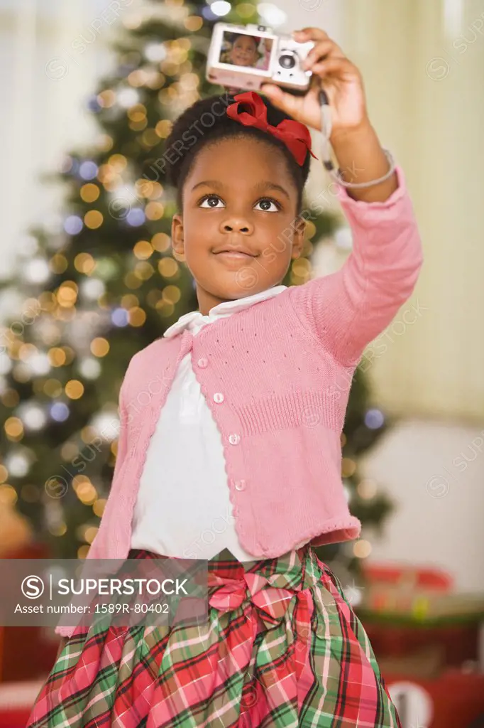 African girl taking self-portrait at Christmas