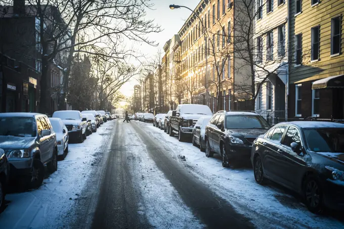 Tire tracks in snow on city street, New York, New York, United States