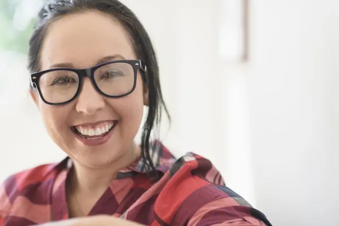 Smiling mixed race woman wearing eyeglasses