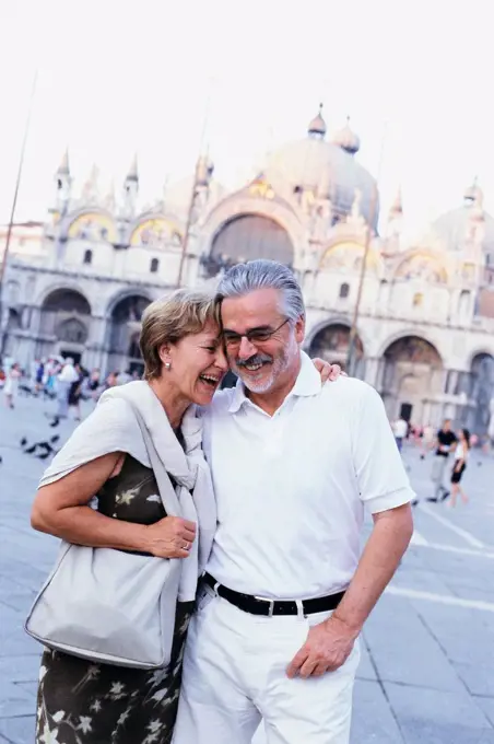 Senior couple hugging in St. Mark's Square, Venice, Veneto, Italy