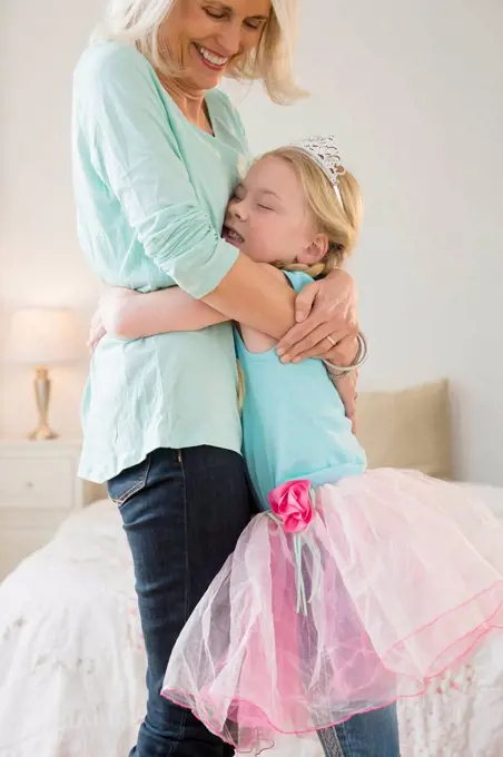 Senior Caucasian woman and granddaughter hugging