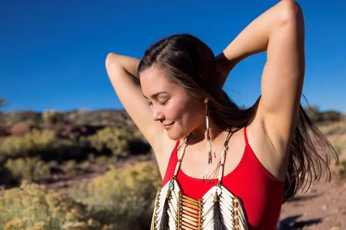 Mixed race woman standing in remote desert landscape