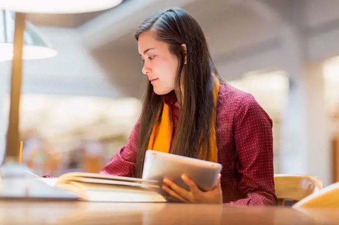 Mixed race student studying in library