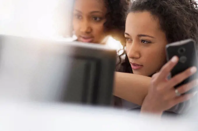 Businesswomen working with cell phone and computer