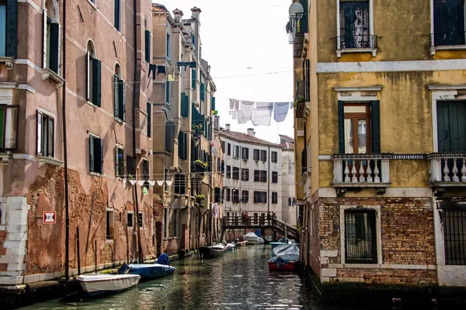 Clotheslines over canal between apartment buildings, Venice, Italy