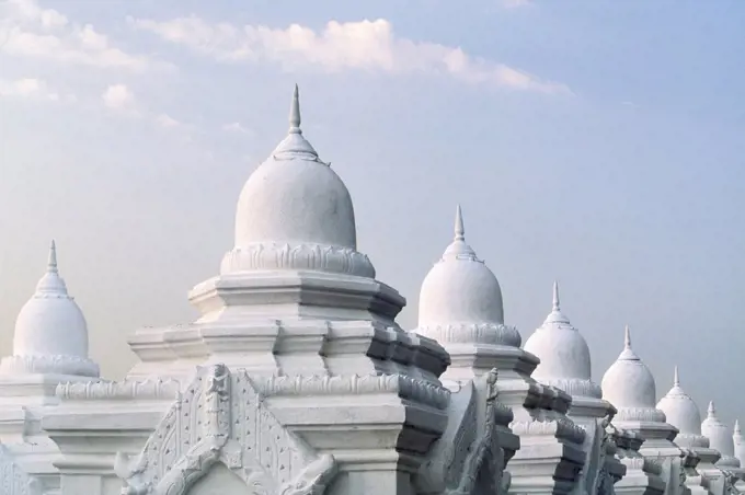 Ornate domes under cloudy sky, Mandalay, Myanmar