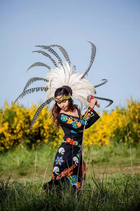 Native American woman in traditional headdress performing ceremony