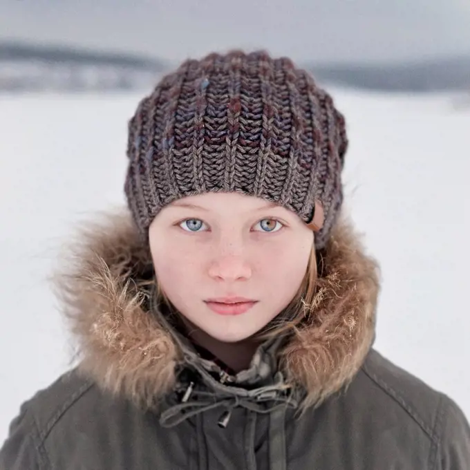 Caucasian teenage girl wearing beanie hat in snow