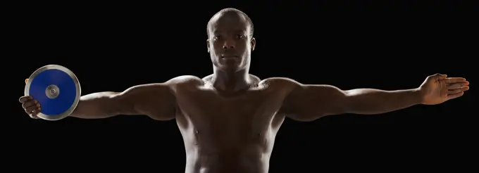 African American man holding track and field discus