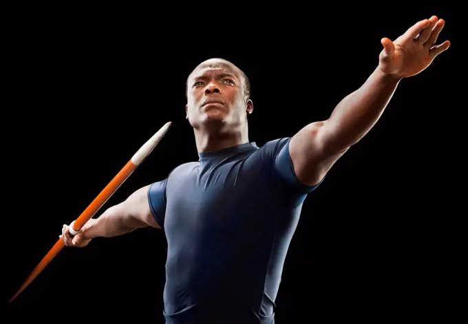 African American man holding track and field javelin