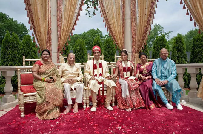 Indian bride and groom with family in traditional clothing