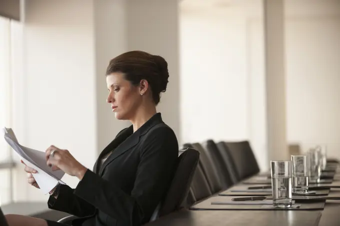 Caucasian business woman working in conference room