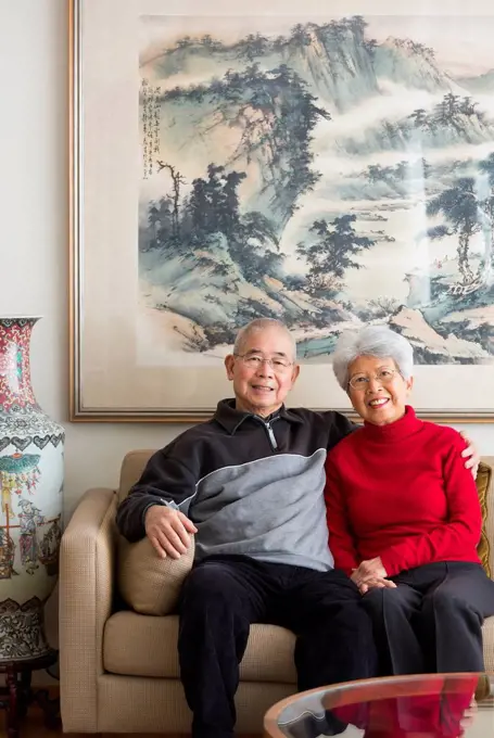 Chinese couple sitting on sofa