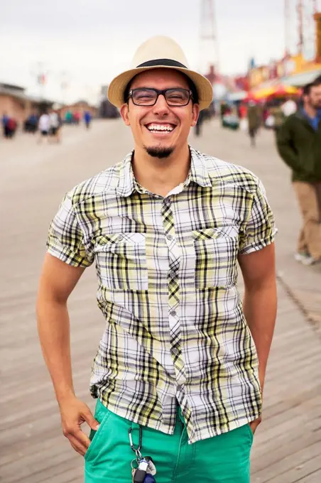 Hispanic man smiling on boardwalk