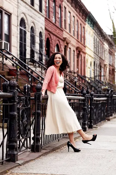 Mixed race woman smiling on city street