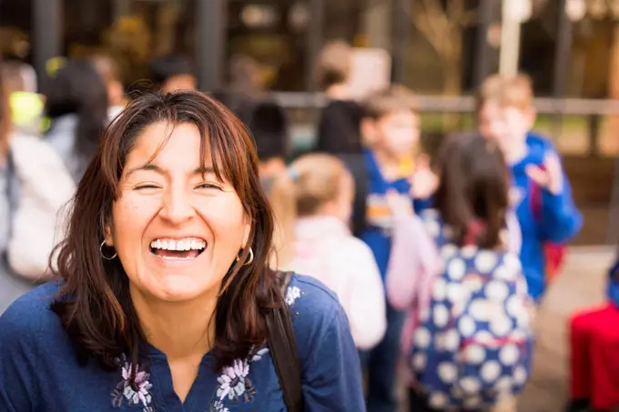 Hispanic woman laughing outdoors