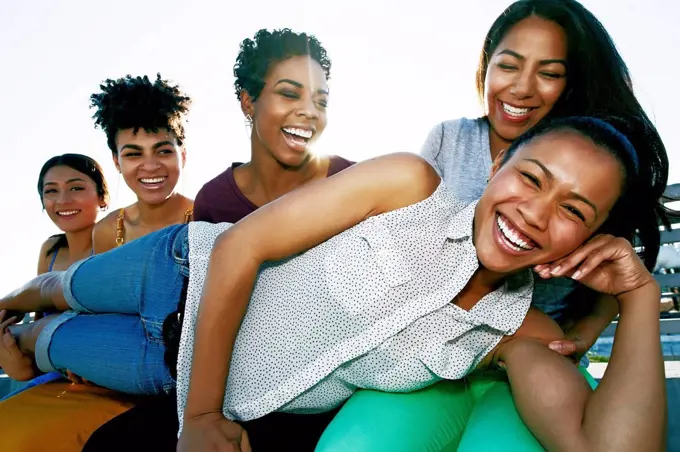 Women smiling on urban rooftop