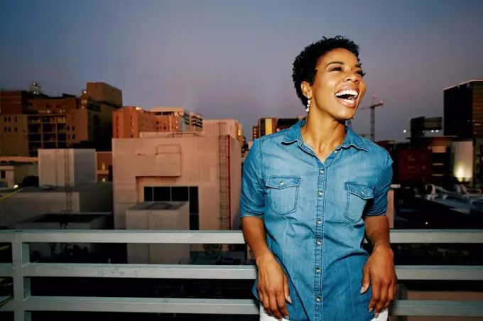 Woman laughing on urban rooftop