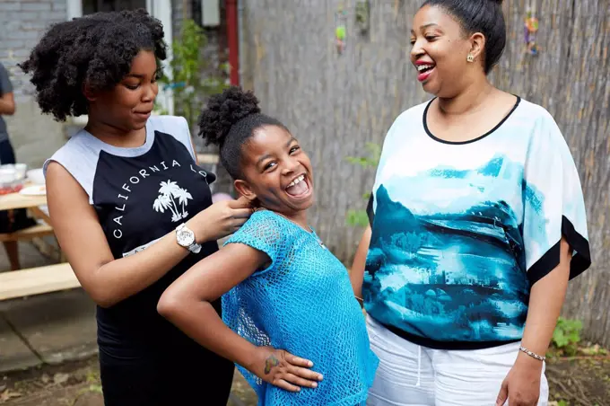 Mother, daughter and aunt relaxing in backyard