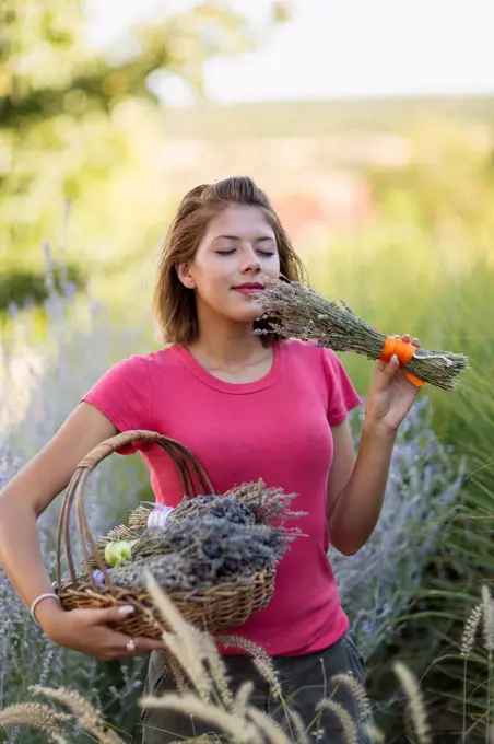 Mixed race woman smelling flowers in garden