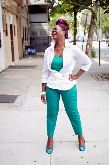 Woman laughing on city street