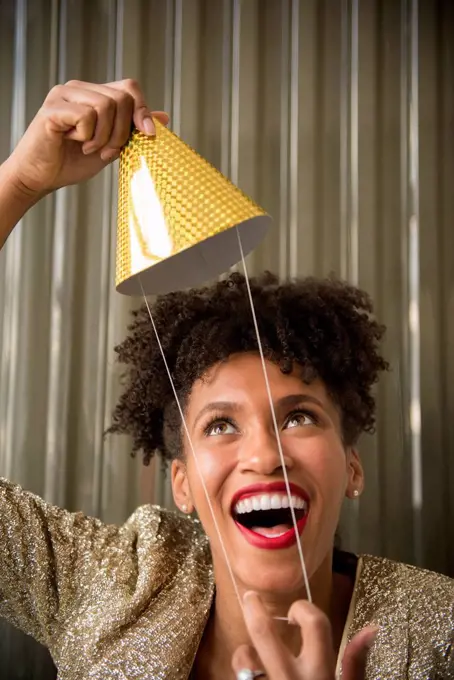 Glamorous Black woman holding party hat