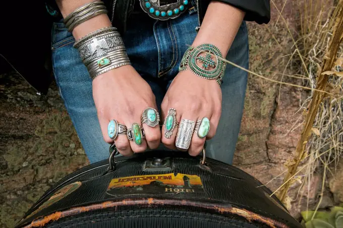 Arms and hands of Caucasian woman wearing ornate jewelry