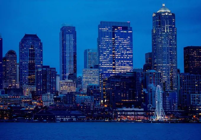 Illuminated city skyline at waterfront