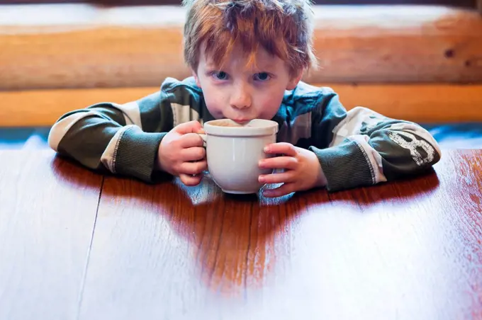 Caucasian boy drinking hot chocolate