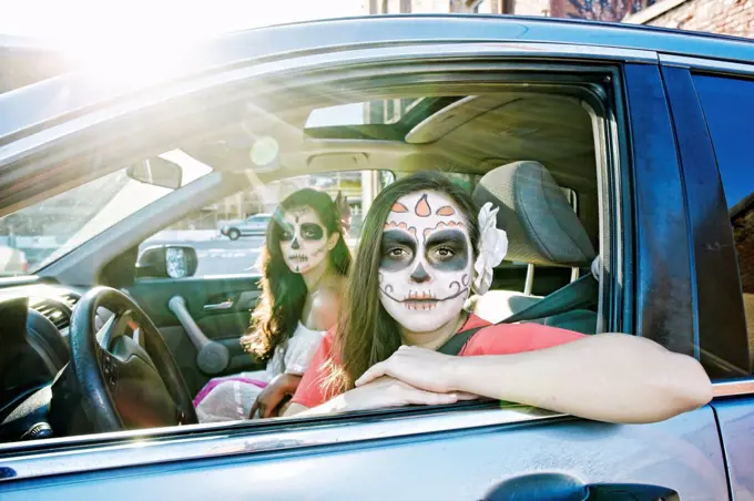 Women in car wearing skull face paint