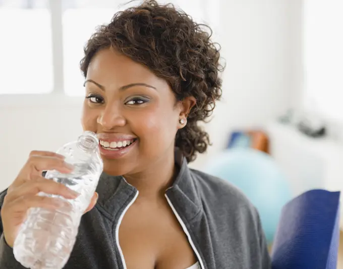 African American woman drinking water