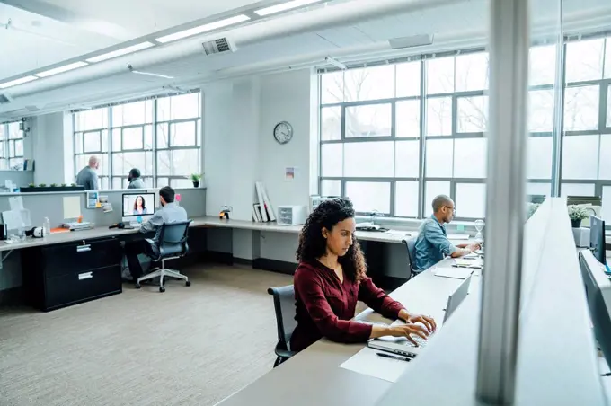 Business people working in busy office