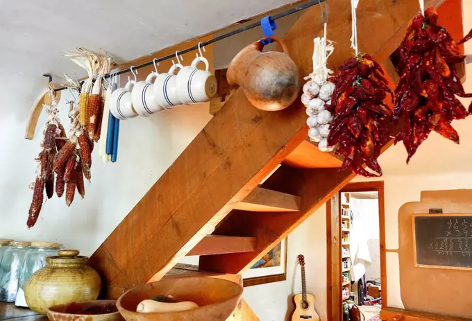 Cups and dried food hanging in traditional indigenous kitchen