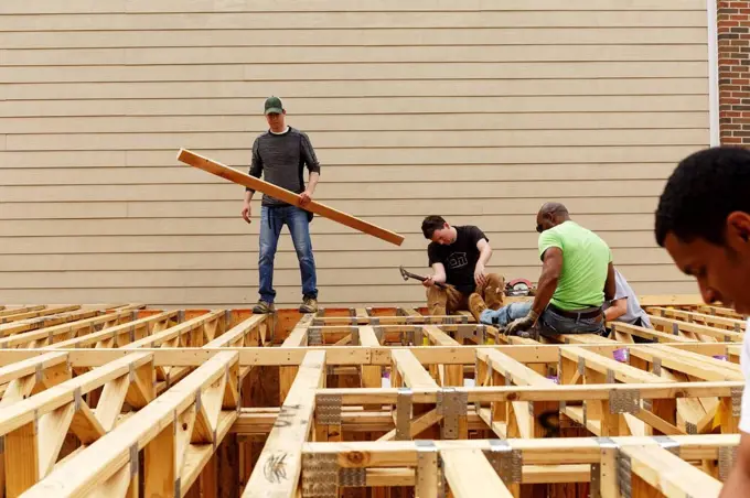 Volunteers on the roof at construction site