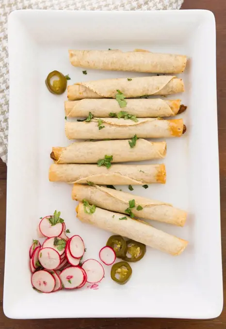 Mexican taquitos on platter