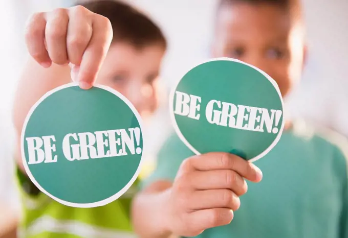 Boys holding Be Green signs