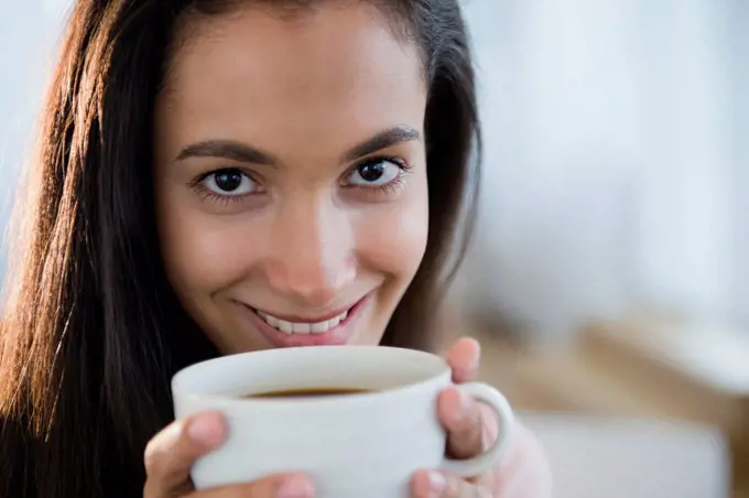 Hispanic teenager drinking coffee