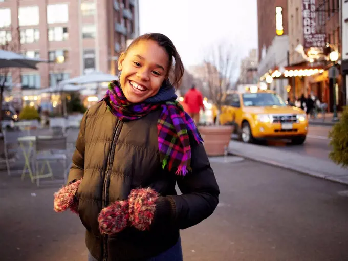 Mixed race girl smiling on city street, New York, New York, United States