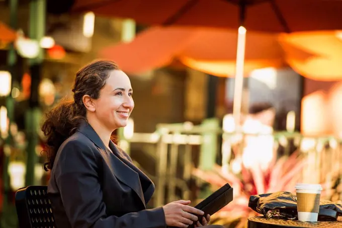 Hispanic businesswoman working at cafe