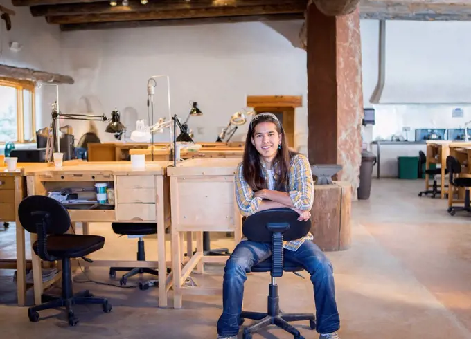 Mixed race man sitting in art studio