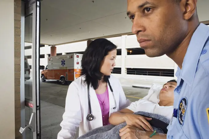 Man on gurney with paramedic and doctor