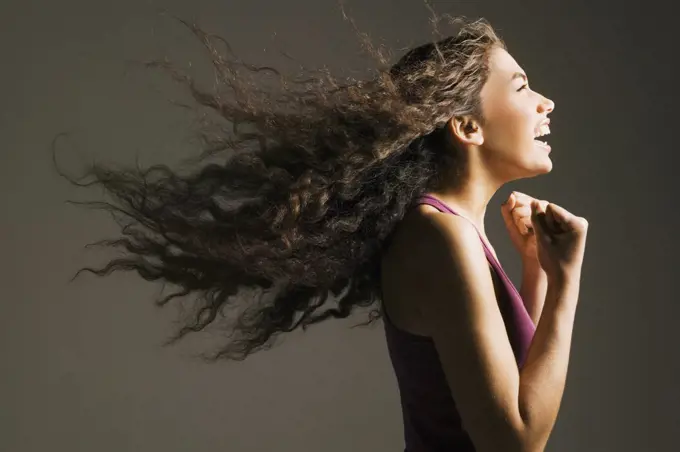 Profile of Asian woman cheering