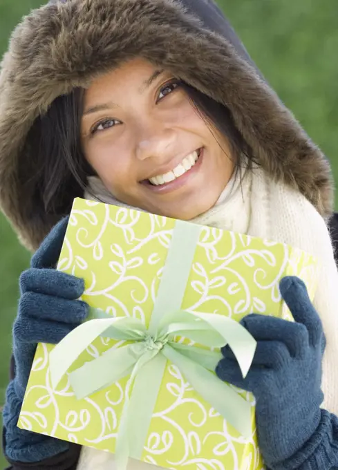 Pacific Islander woman holding gift