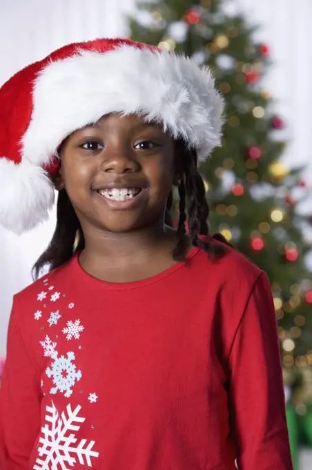 African girl wearing Santa Claus hat