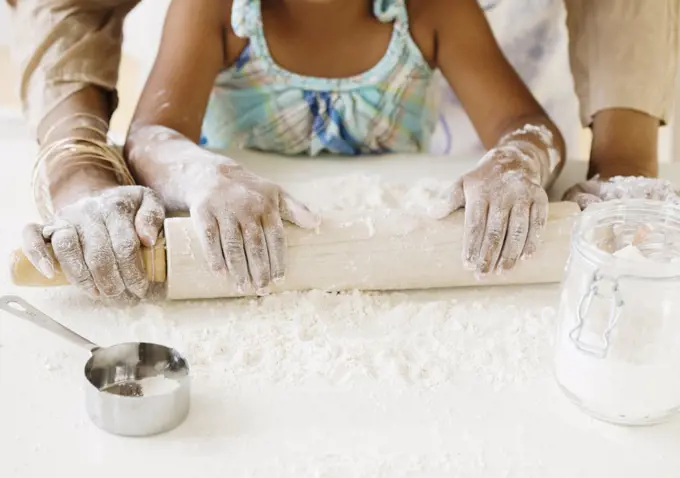 African grandmother baking with granddaughter