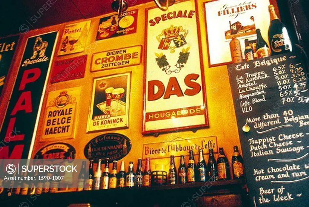 Netherlands, Amsterdam, Wall in bar decorated with old fashioned adds.