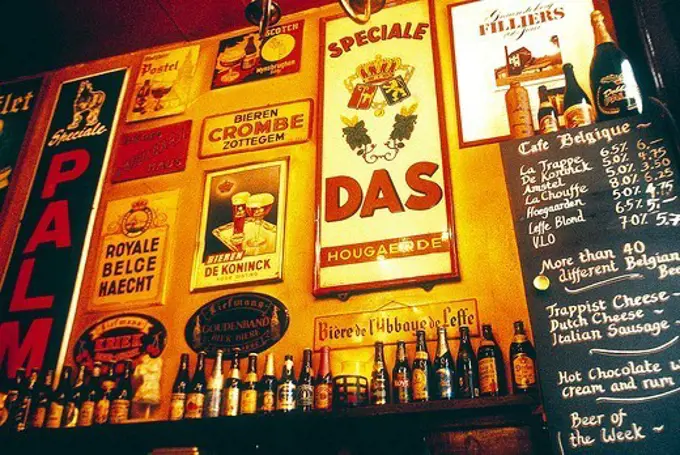 Netherlands, Amsterdam, Wall in bar decorated with old fashioned adds.