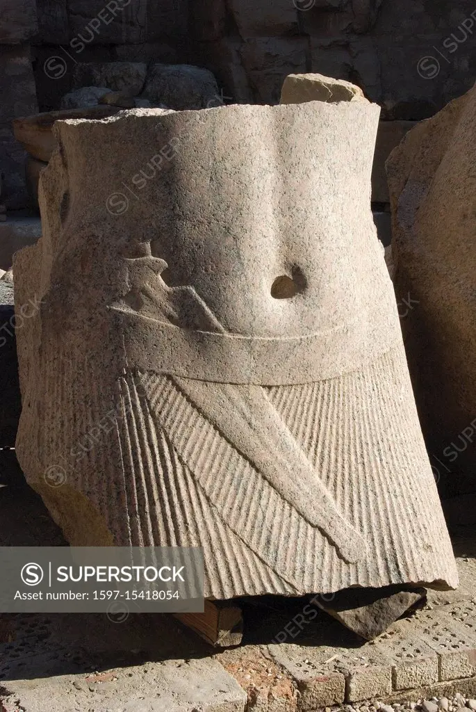 Karnak, Luxor, Egypt. Temple of Karnak sacred to god Amon: a remaining of a statue with the shendit and a dagger.